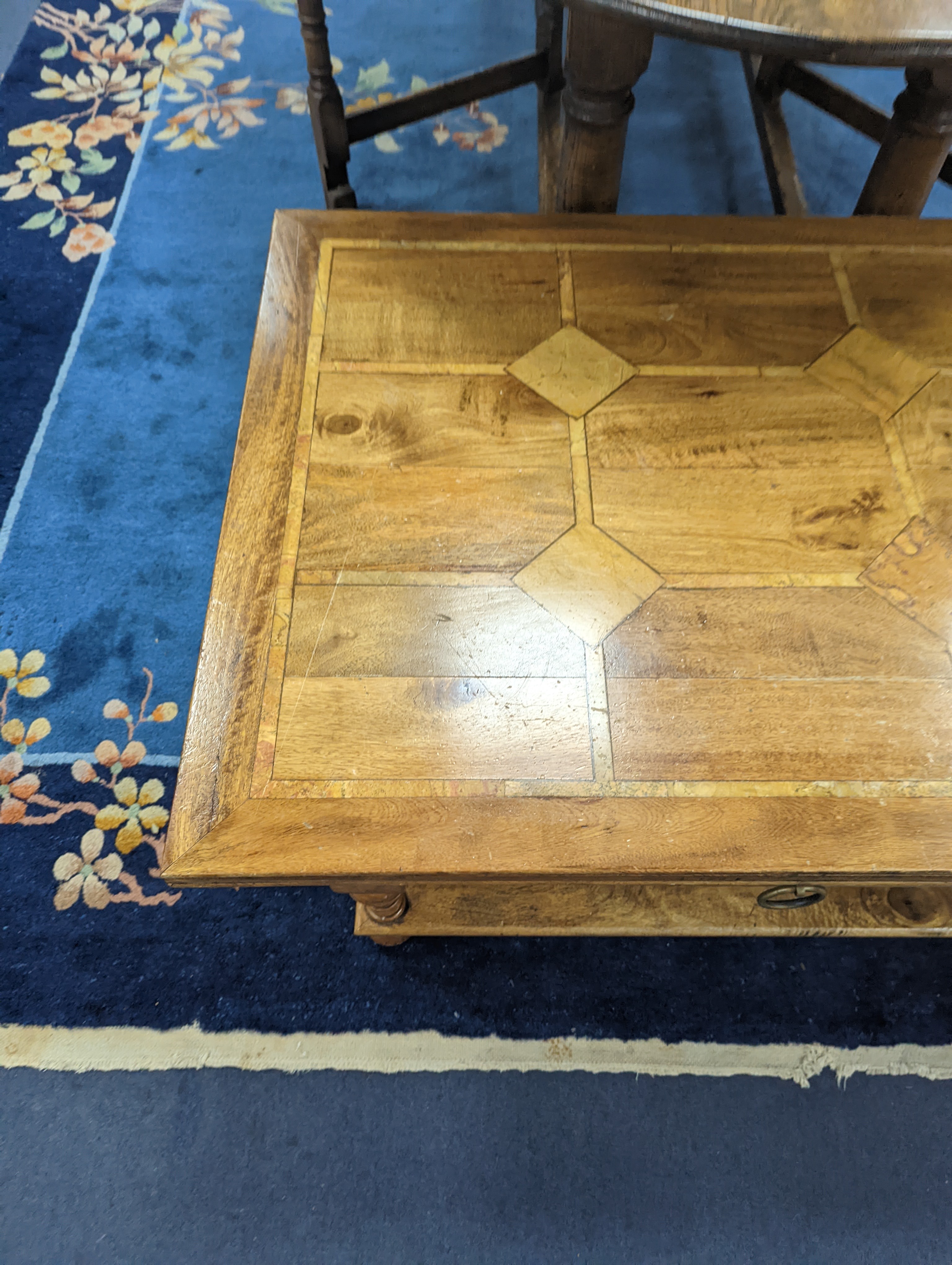 A hardwood and marble inset coffee table, length 130cm, depth 80cm, height 45cm